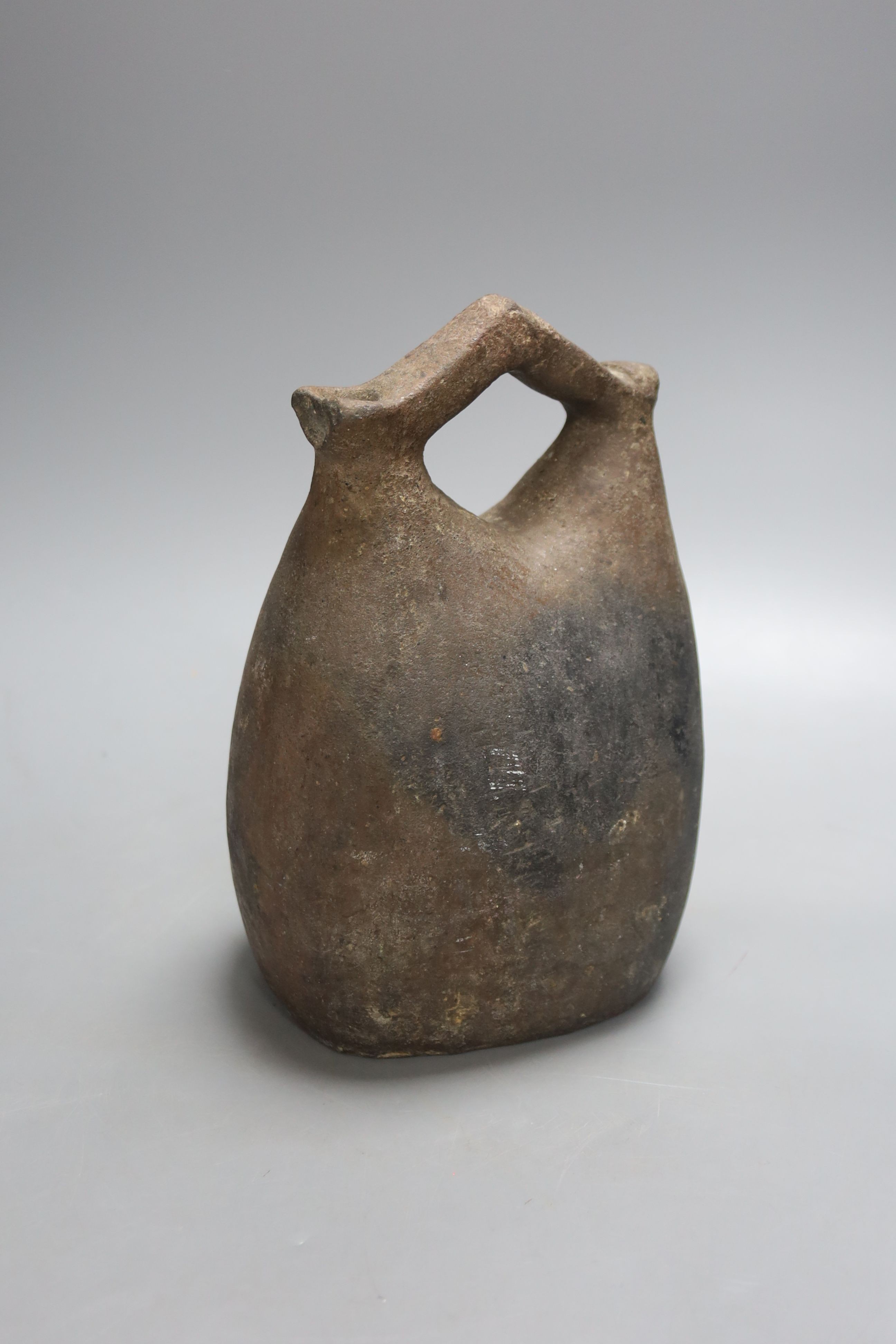 An Egyptian pottery flask, 23 cms high